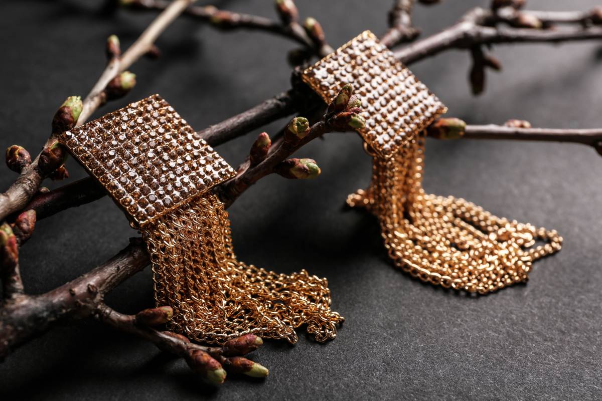 Gold earrings on tree branch