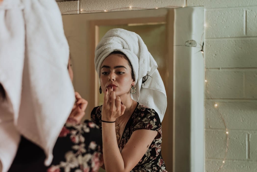 Young Woman Fixing her Makeup