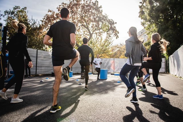 a group of young people exercising outdoors