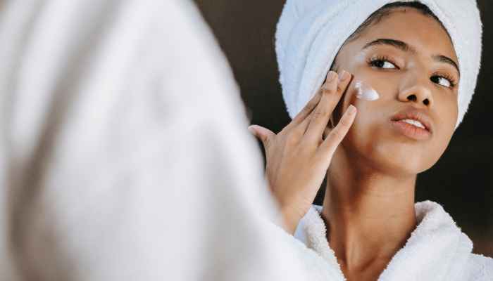 woman getting face cream on her face