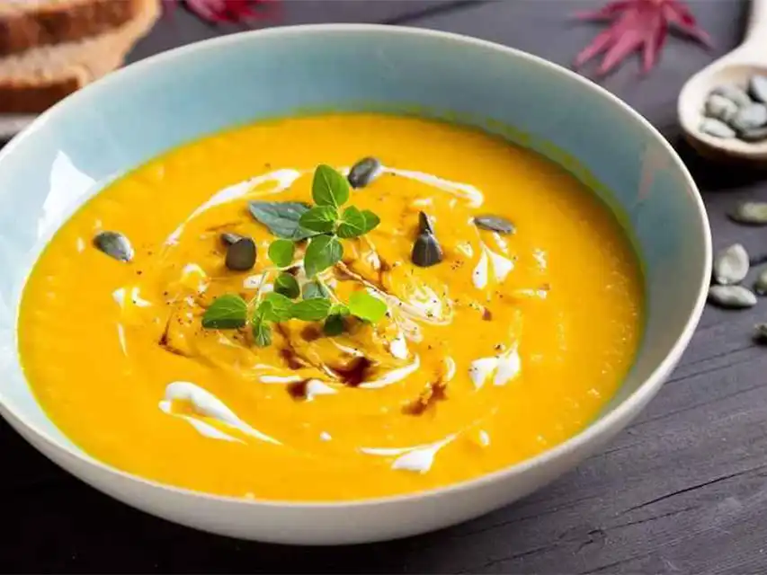 a bowl of soup with leaves on top