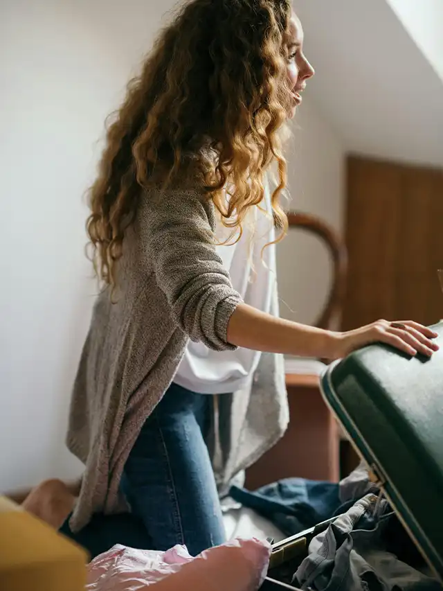 a woman with long hair and a suitcase