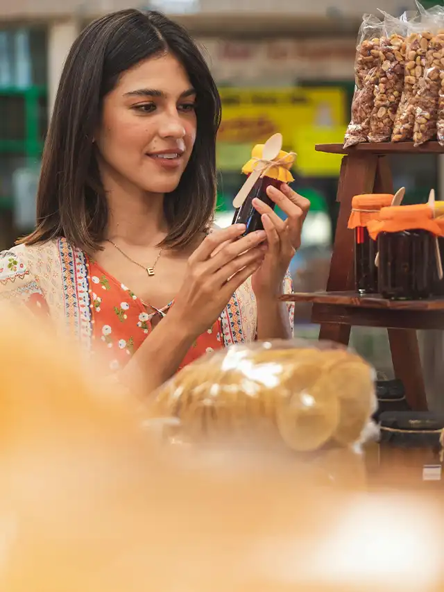 a woman holding a bottle of liquid