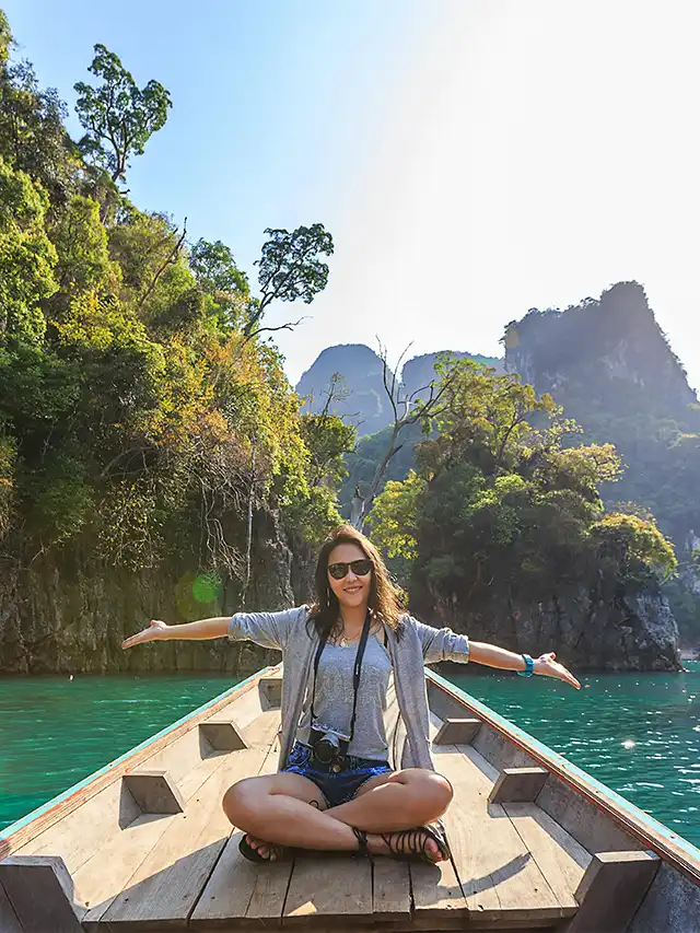 a woman sitting on a boat in the water