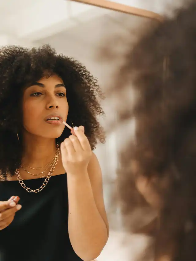 a woman putting on makeup