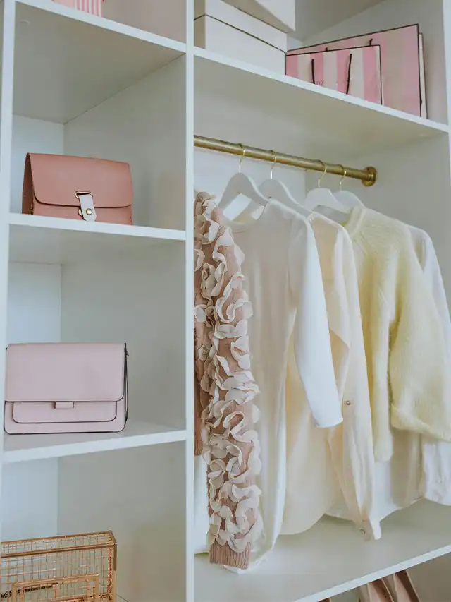 a closet with clothes and purses