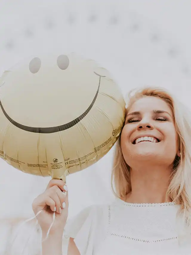 a woman holding a balloon