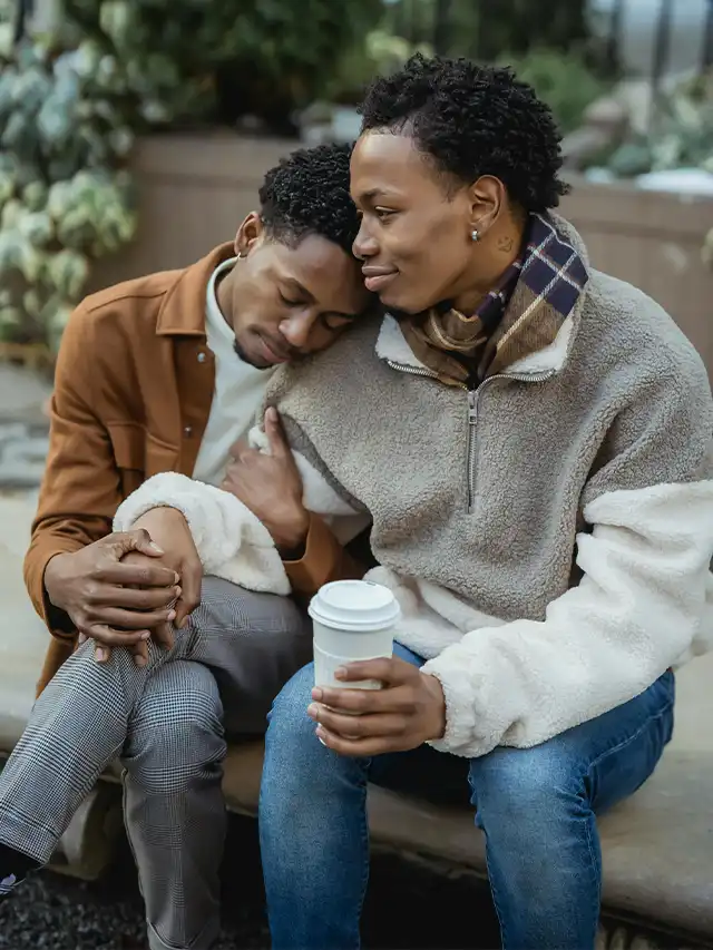 a man and woman sitting on a bench