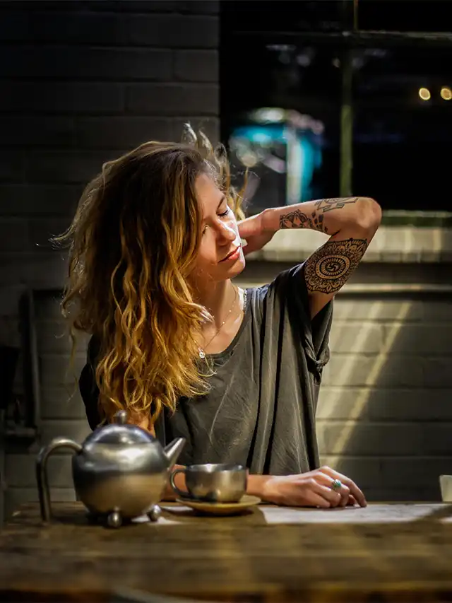 a woman with tattoos on her arm